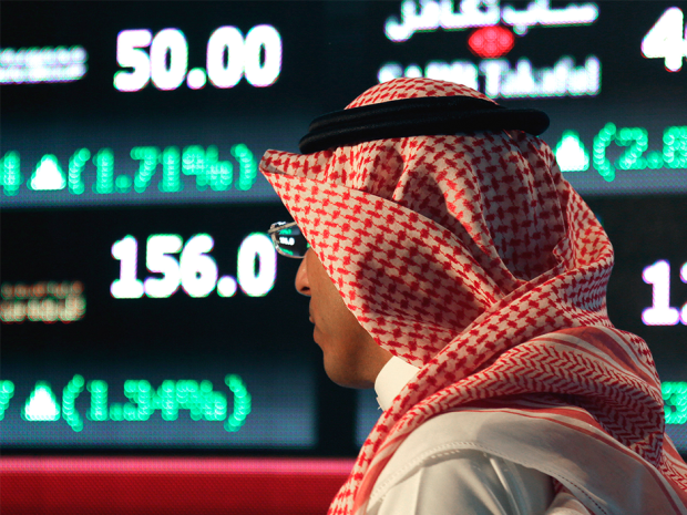 A Saudi man walks at the Tadawul All Share Index in Riyadh. Saudi Arabia opened its stock market to direct foreign investment in 2015 and is planning to expand on those efforts.