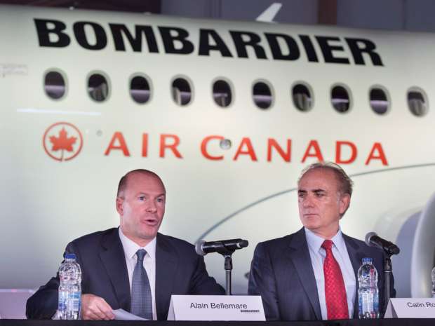 Calin Rovinescu, right, president and CEO of Air Canada, listens to Alain Bellemare, president and CEO of Bombardier Inc., during a news conference Wednesday, February 17, 2016 in Montreal.