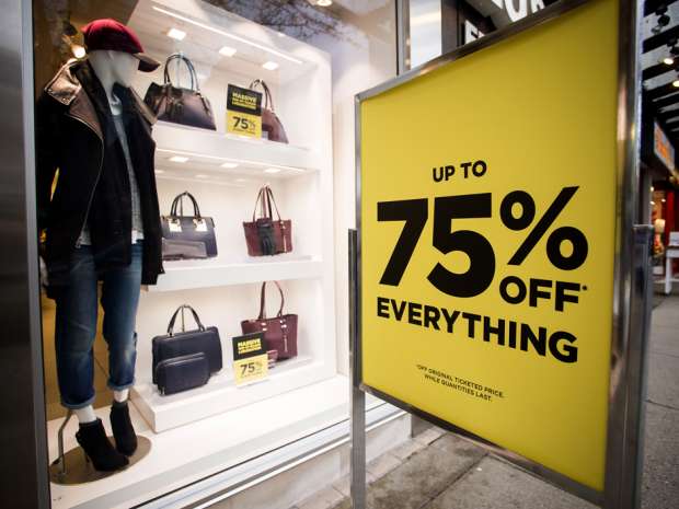 A sale sign is displayed outside of a Danier Leather store in downtown Vancouver, British Columbia, Canada.