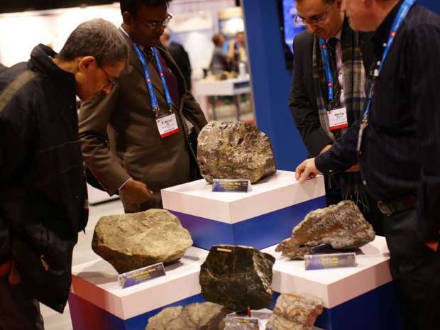 People look at minerals from a mine in Newfoundland at the Prospectors & Developers Association of Canada 2016 convention.