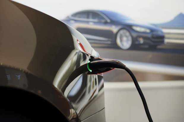 A Model S 85 electric vehicle (EV) is charged at the Tesla Motors Inc. retail store in San Jose, California, U.S.