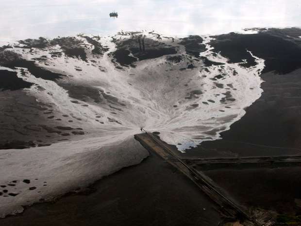 A tailings pond is pictured at an oilsands mine facility near Fort McMurray, Alta. A study released Monday criticized the Joint Oil Sands Monitoring initiative, a team effort by environmental agencies in Ottawa and Edmonton, because the partnership has yet to publish annual reports on the data it has collected.