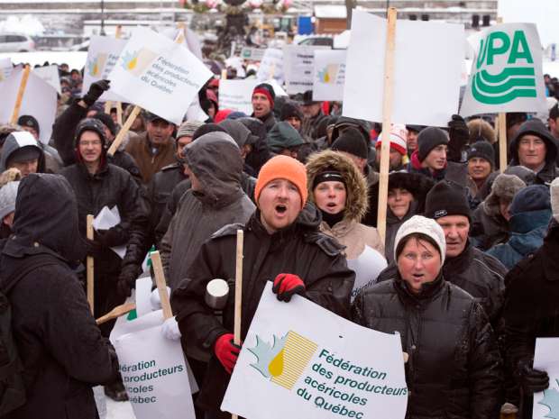 Quebec maple syrup producers demonstrate in front of the Quebec legislature, Tuesday, Feb. 16, 2016.