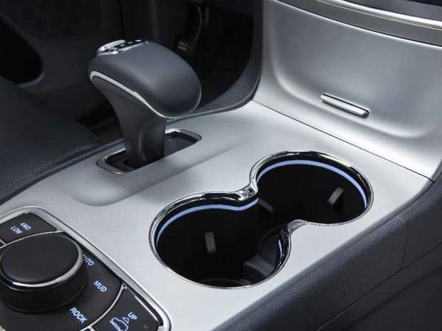 This photo provided by Fiat Chrysler Automobiles shows the interior of a 2014 Jeep Grand Cherokee Overland. U.S. auto safety investigators have determined that electronic gear shifters, like the one at upper left, in some newer Fiat Chrysler SUVs and cars are so confusing that drivers have exited the vehicles while they are in gear, causing 121 crashes and 30 injuries. 