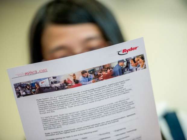 A job seeker looks at a flyer from Ryder Systems Inc. during a career fair at San Francisco State University in San Francisco, California. Nonfarm payrolls increased by 151,000 jobs last month and the unemployment rate was at 4.9 percent, the lowest since February 2008, the Labor Department said on Friday.