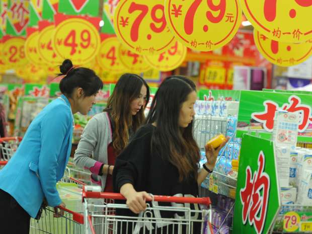Customers browse goods in a supermarket in Fuyang, east China's Anhui province. Those who fear China's growth story is over should note that only half of its 1.4 billion people are urbanized.