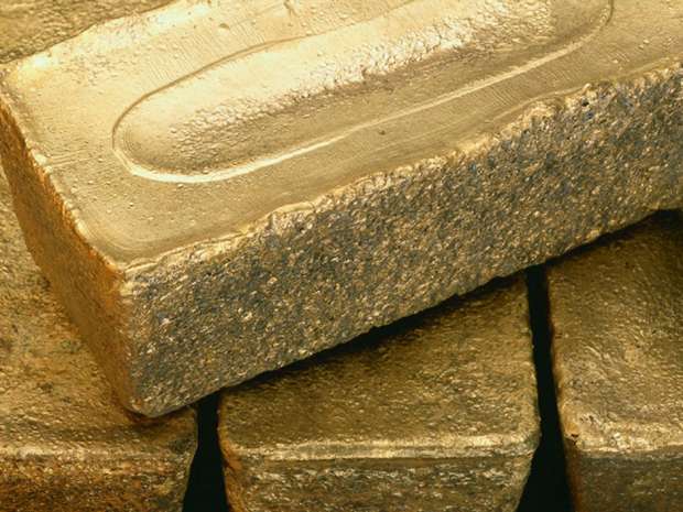 Barrick Gold warned investors it will be writing down the value of mines in Chile and Dominican Republic and promised more details next month.