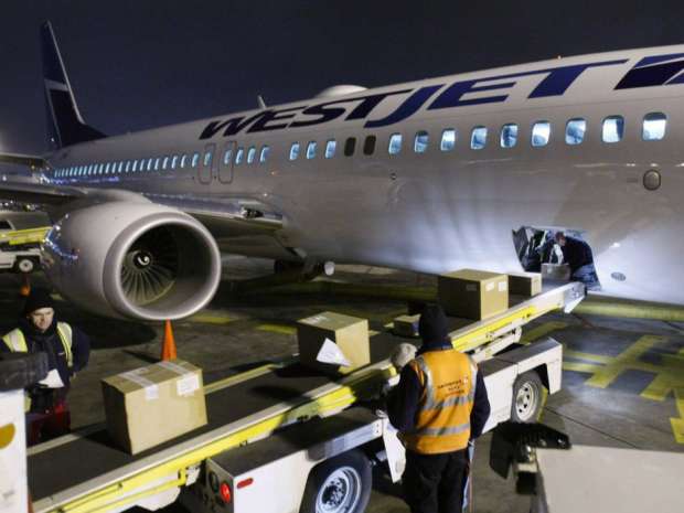 A West Jet 737 is packed full of goods Monday night to be taken to Haiti.