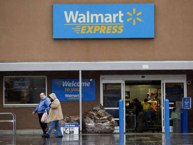 Customers exit a Wal-Mart Express store in Richfield, North Carolina, U.S. Wal-Mart Stores Inc. plans to close 269 store, including its experimental small-format Express outlets.