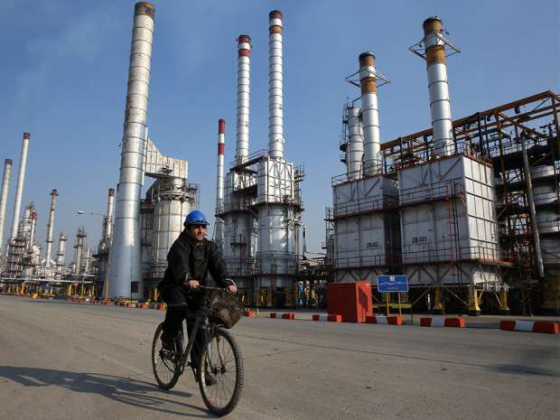 An Iranian oil worker rides his bicycle at the Tehran's oil refinery south of the capital Tehran. A European oil embargo on the world's seventh-largest oil producer has ended following the lifting of trade sanctions last weekend.
